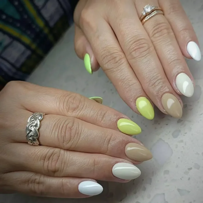 A simple oval nail idea featuring a gradient manicure with earthy tones and a pop of lime green.