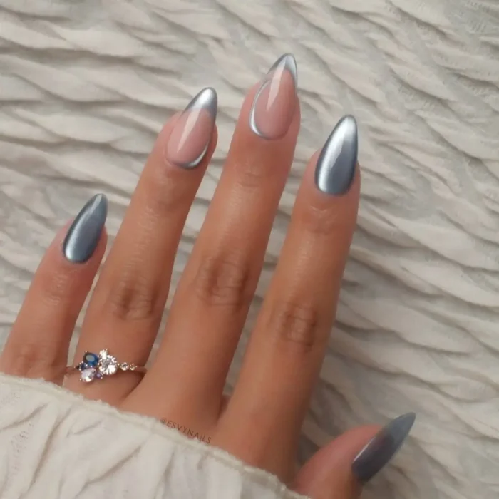 Almond nails with a mix of silver chrome french tips and full-coverage silver chrome nails.